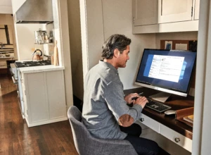 Man interacting with an Asus VivoBook desktop PC.