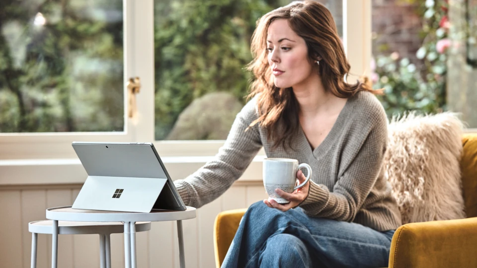 Woman interacting with a Surface Pro laptop.