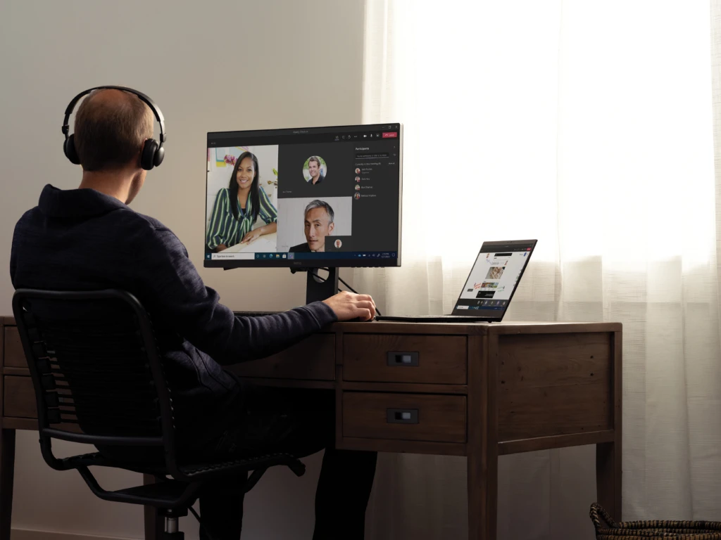 Teams call with headphones at a home desk on a Lenovo ThinkPad X1 Carbon. Keywords: remote work, remote working, work from home, working at home, home office, telecommuting, video conference, video call, Microsoft Teams