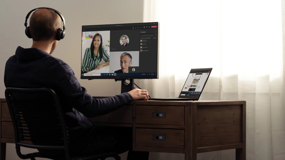 Teams call with headphones at a home desk on a Lenovo ThinkPad X1 Carbon. Keywords: remote work, remote working, work from home, working at home, home office, telecommuting, video conference, video call, Microsoft Teams