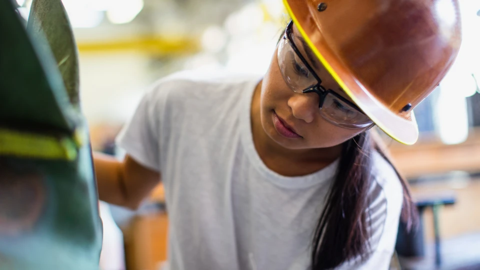 Female worker in shipbuilder‘s machine shop.