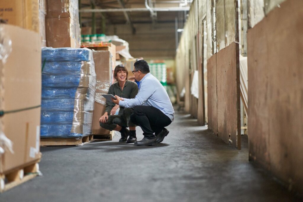 CEO and COO of a textile manufacturing plant working together on the warehouse floor.