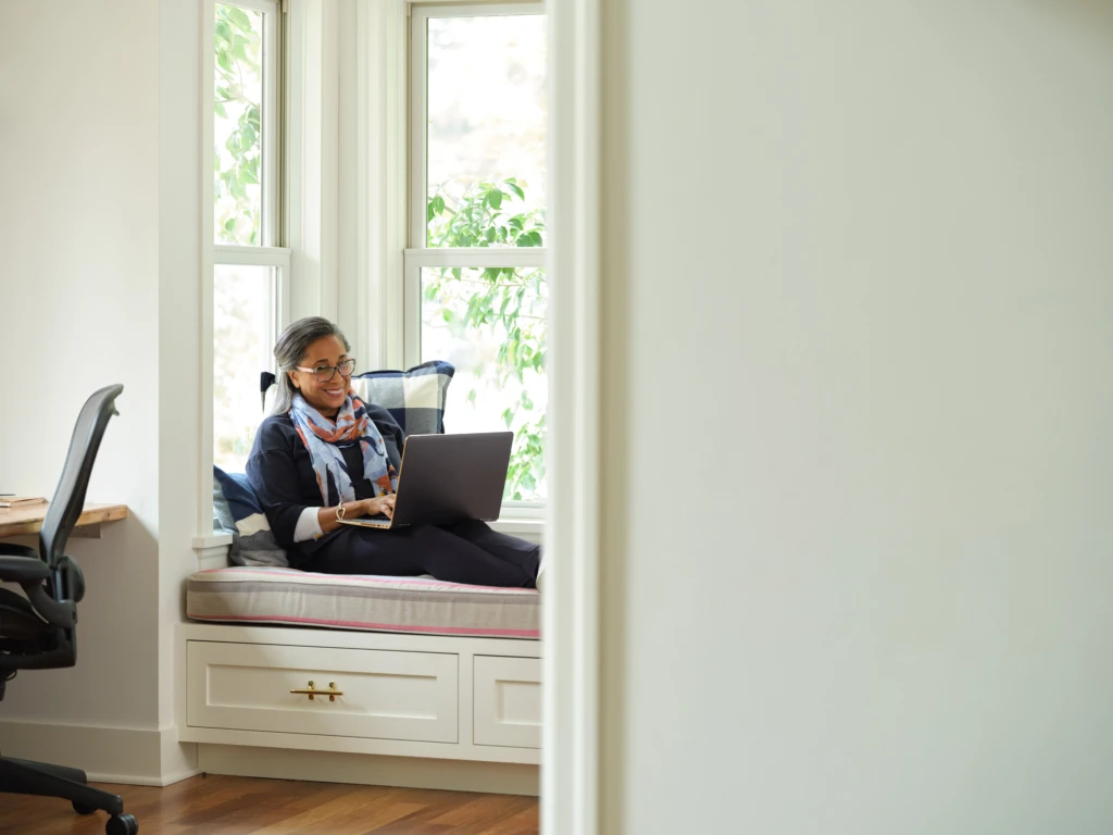 Woman working in a home office. Microsoft 365 Business Premium Female, home office, owner, collaboration, remote work