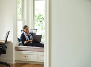 Woman working in a home office. Microsoft 365 Business Premium Female, home office, owner, collaboration, remote work