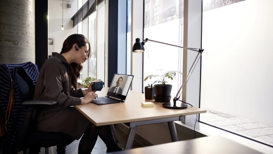 Female small business professional at desk using an Acer Spin 1 device running Microsoft Teams video conference call.