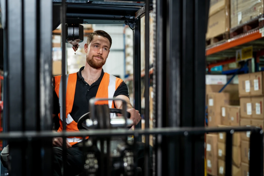 Person in warehouse driving forklift