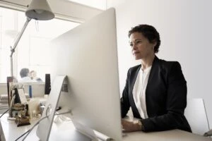 Business woman in office with Desktop PC