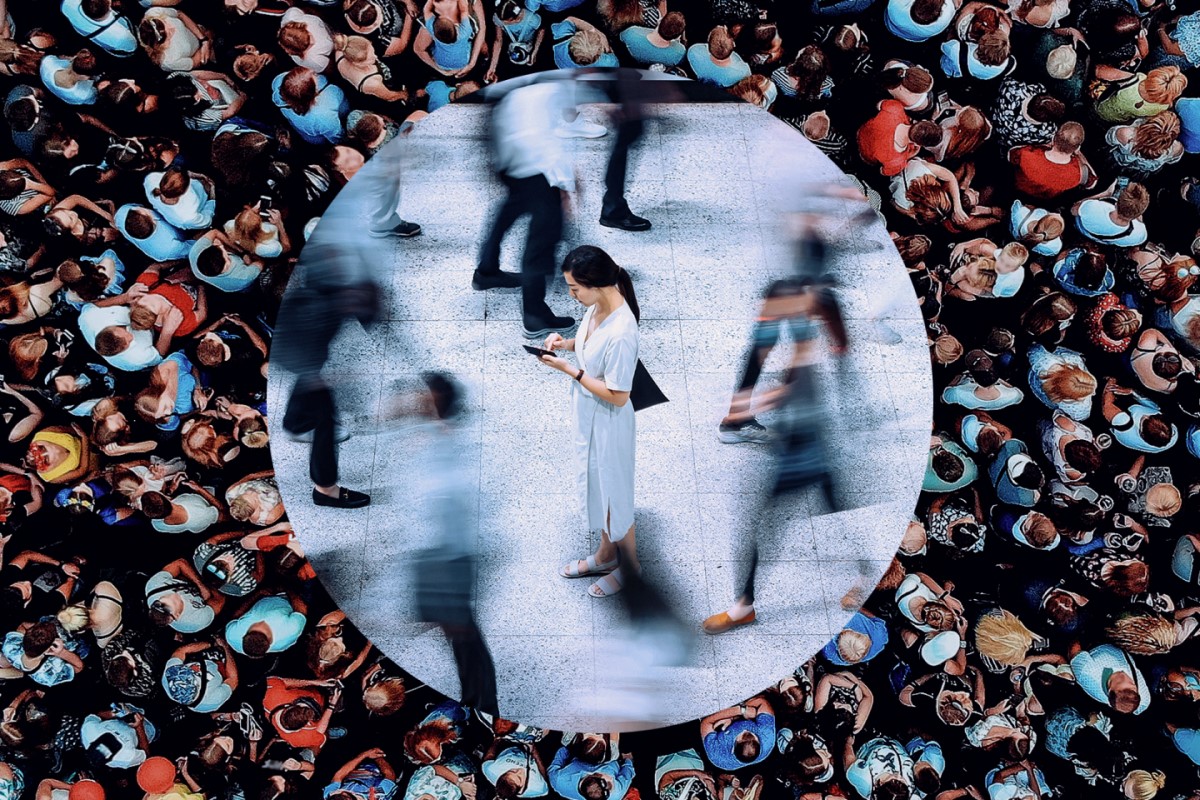 Woman standing in a crowd of people