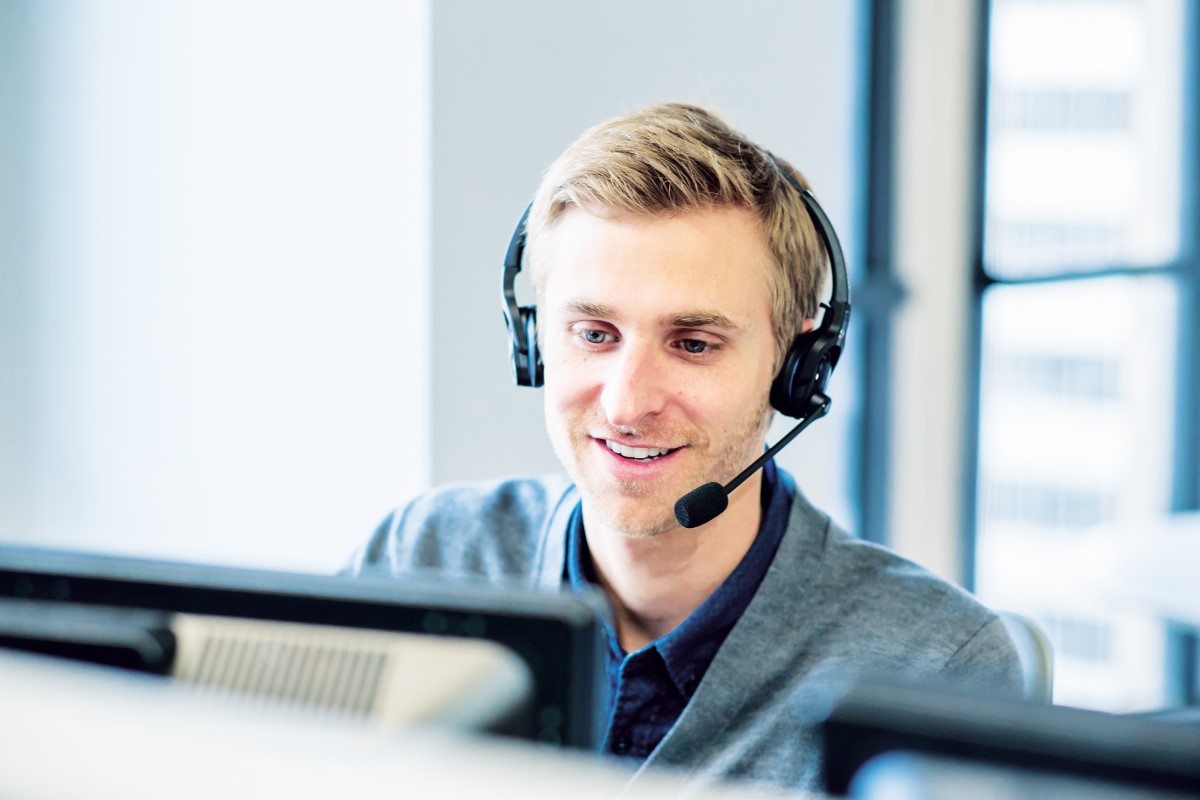Man with headset at computer.