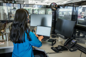 Photo of a female call center employee working at a standing desk.