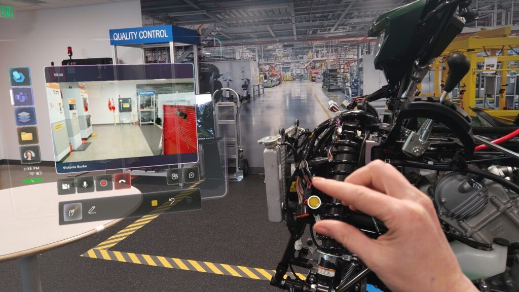 Photo of a mixed reality view of a guide to repairing factory equipment as seen by a HoloLens user.