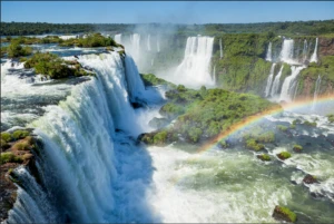 a large waterfall over some water with Iguazu Falls in the background