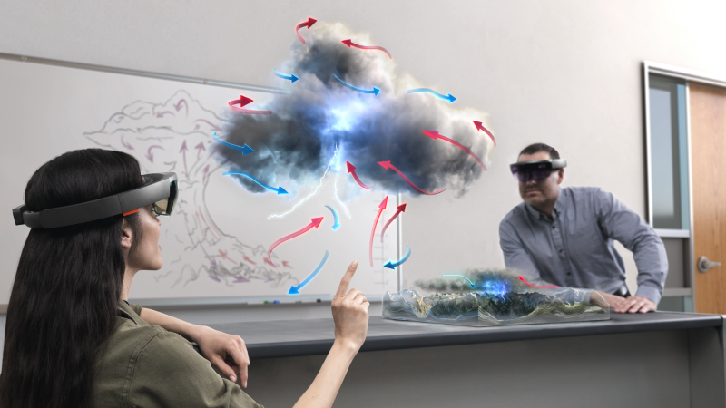 Male and female coworkers use AI and HoloLens to look at cloud formations