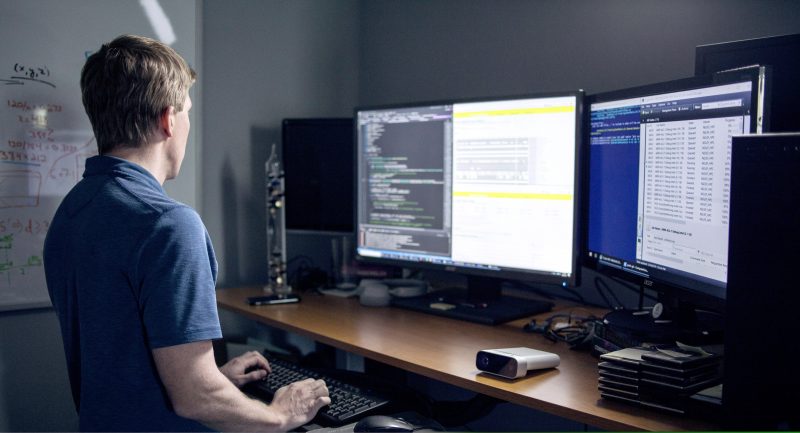 Software developer typing at a computer.