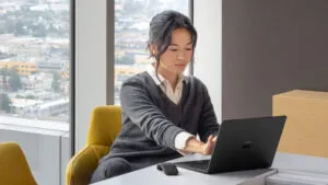 woman at desk working on laptop