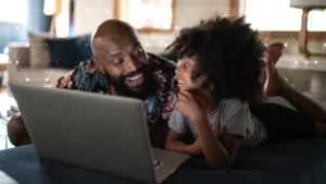 Father and daughter infront of laptop