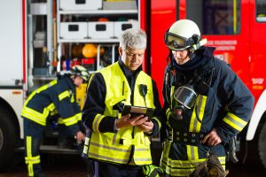 two firefighters analyze data on a Surface book
