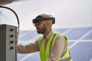 Field engineer inspects solar panels on a wind farm using remote assist with Hololens2.