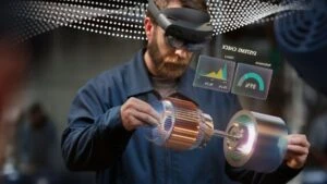 Man in manufacturing plant accessing data via Microsoft Azure. Contains hologram scenario.
