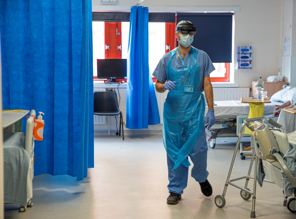 An NHS doctor at St. Mary’s hospital performs a ward round on a COVID-19 ward whilst wearing a Microsoft HoloLens 2