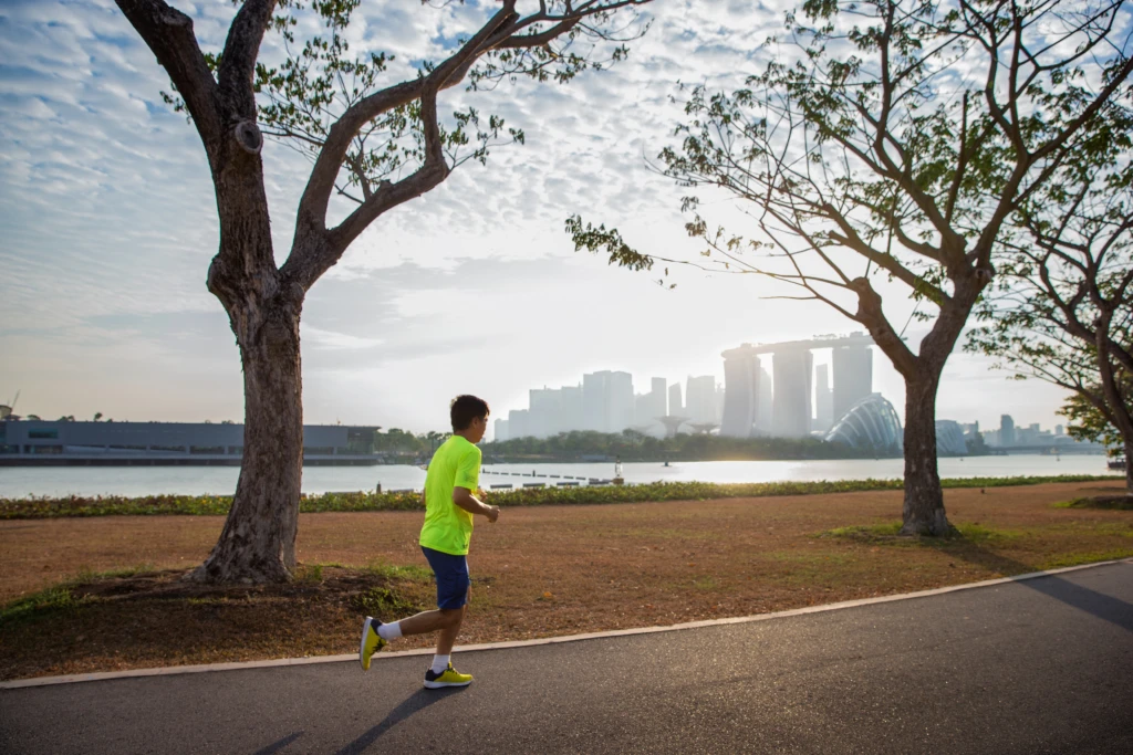 A runner with a city in the distance. Global sustainability plans include reaching net zero.