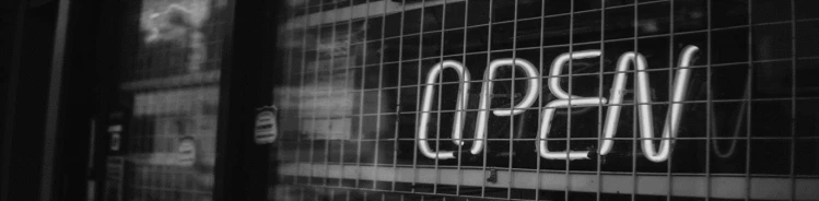 A black and white photo of an open sign