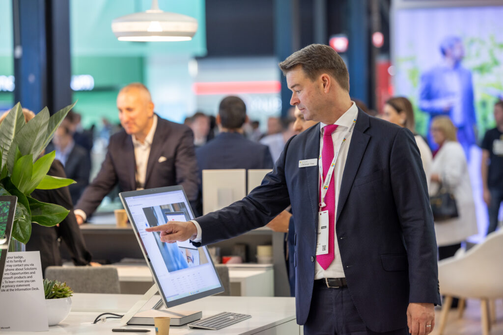 Man in a suit using a device at Sibos.