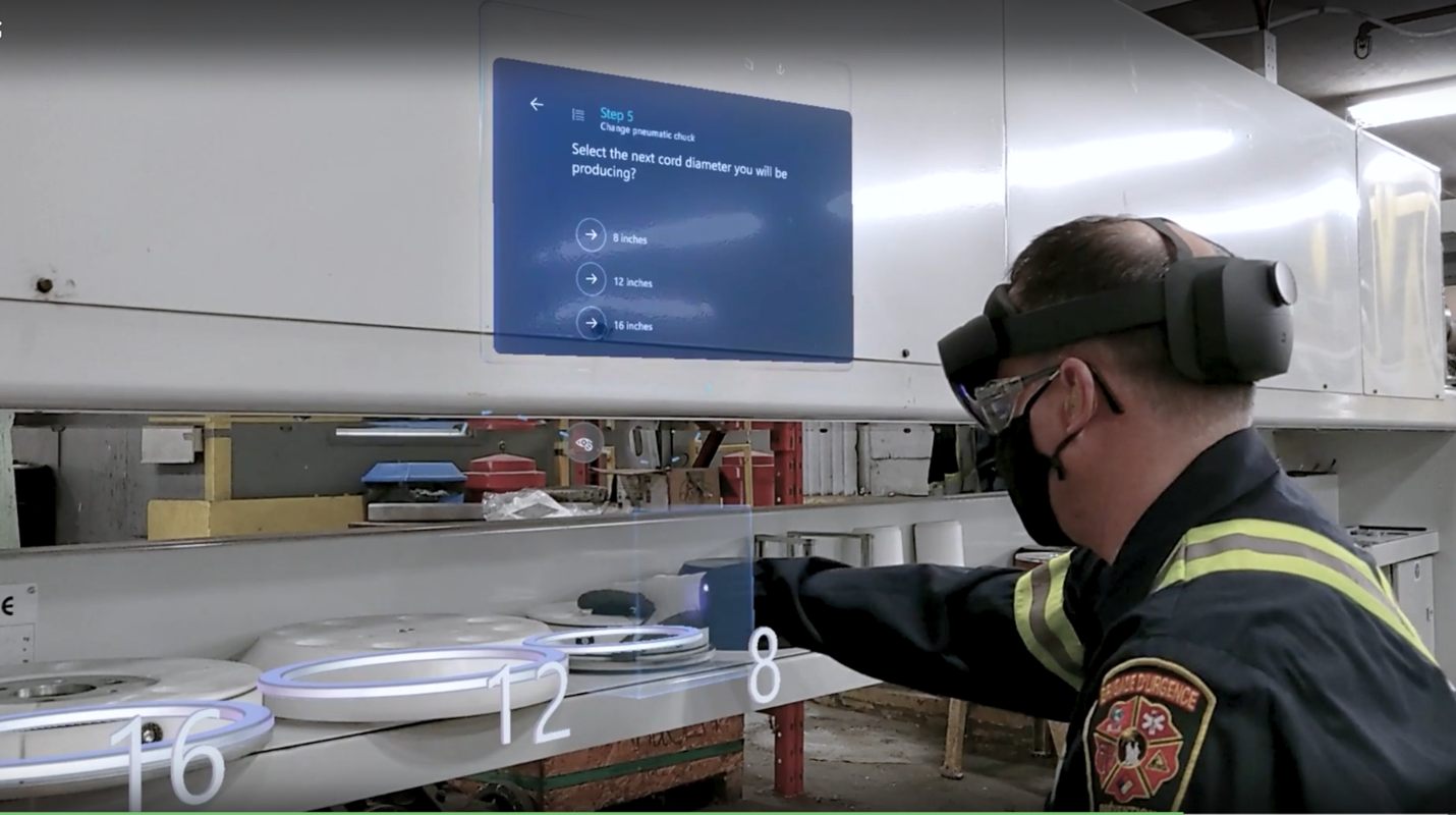 A worker wearing Microsoft HoloLens with a Dynamics 365 Guides prompt displayed