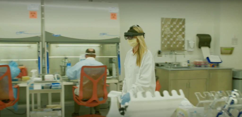 A person walking through a laboratory wearing HoloLens