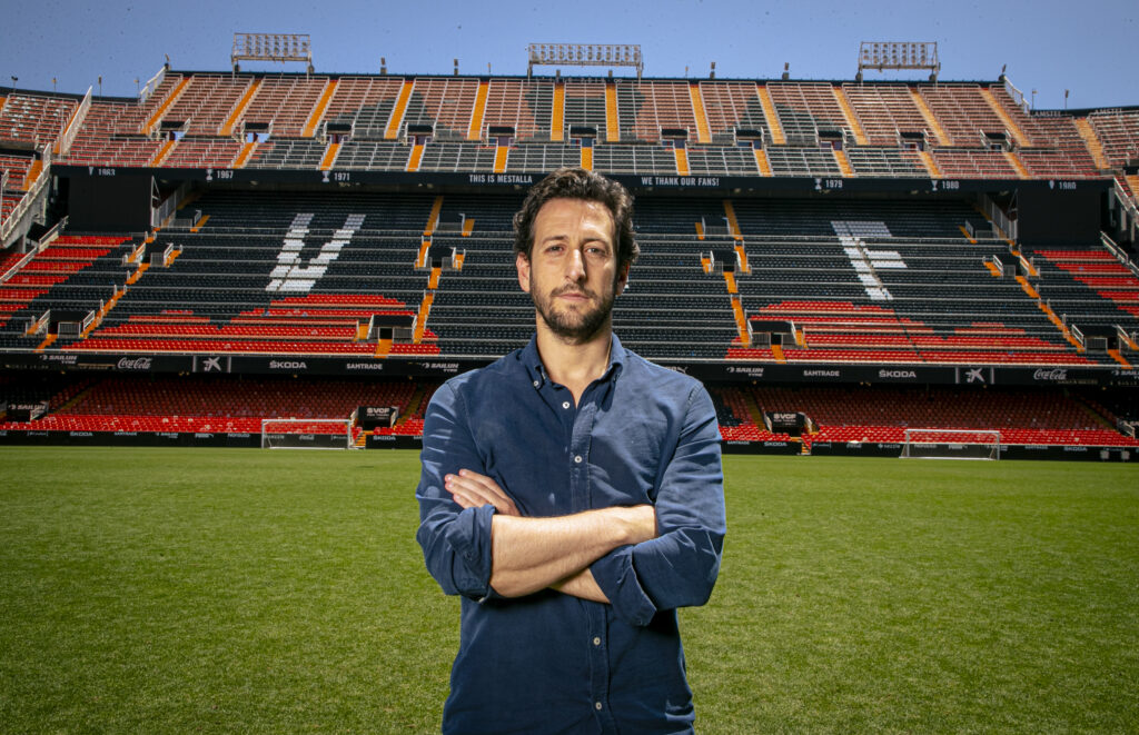 a man standing next to a stadium